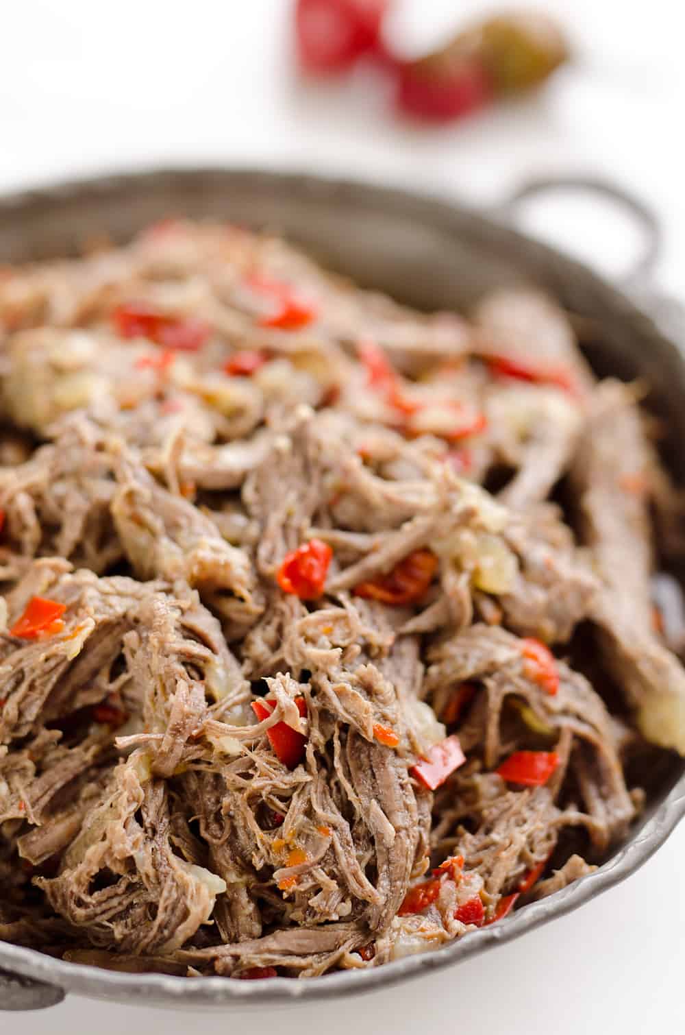 Pressure Cooker Shredded Italian Beef is an easy no fuss recipe made with simple ingredients! Serve this beef along with your favorite veggies for a healthy low-carb dinner idea or pile it high on fresh buns for a delicious sandwich!