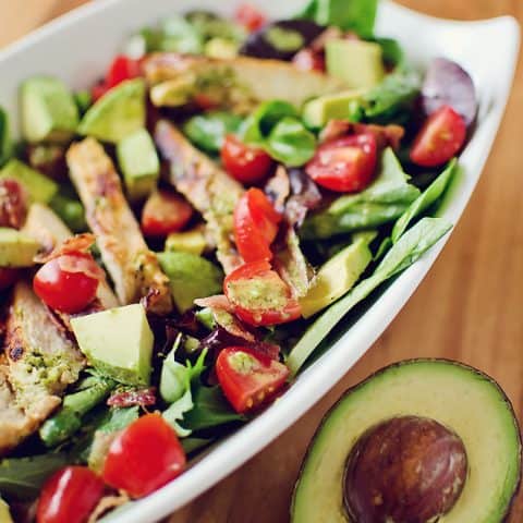 Chicken BLT Salad with Citrus Tomatillo Dressing served with avocado