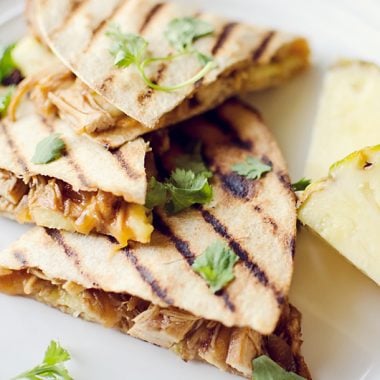 Crock Pot BBQ Chicken Pineapple Quesadillas on plate with slices of pineapple