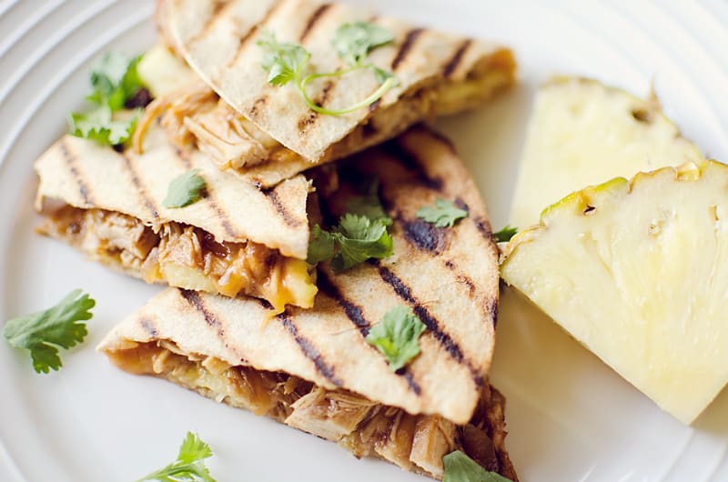 Crock Pot BBQ Chicken Pineapple Quesadillas on plate with slices of pineapple
