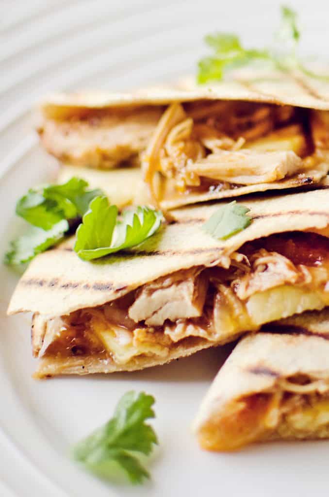 Crock Pot BBQ Chicken Pineapple Quesadillas on white plate garnished with cilantro