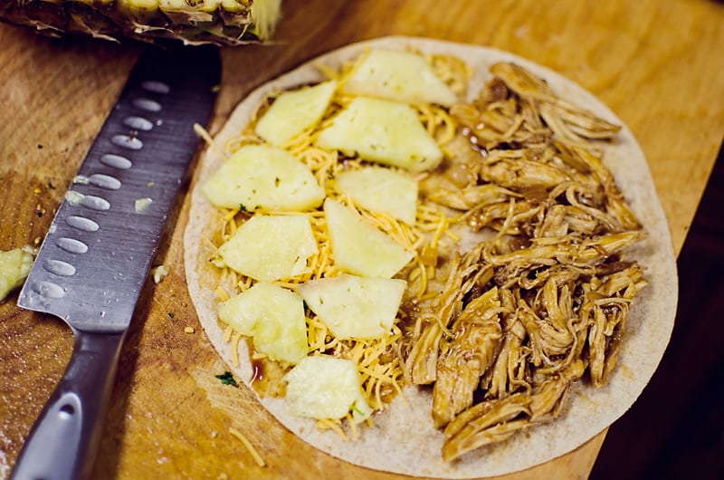 Crock Pot BBQ Chicken Pineapple Quesadillas being made on cutting board