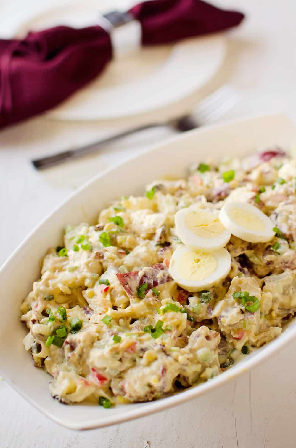 Roasted Garlic & Red Skin Potato Salad is a delicious twist on creamy potato salad with roasted garlic and bacon. This hearty salad is sure to be a hit at your next picnic or potluck!