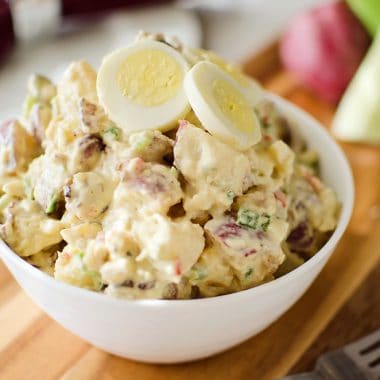 Roasted Garlic & Red Skin Potato Salad is a delicious twist on creamy potato salad with roasted garlic and bacon. This hearty salad is sure to be a hit at your next picnic or potluck!