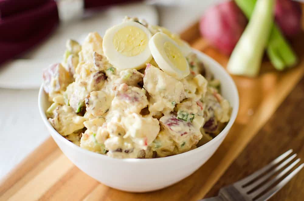Roasted Garlic & Red Skin Potato Salad is a delicious twist on creamy potato salad with roasted garlic and bacon. This hearty salad is sure to be a hit at your next picnic or potluck!
