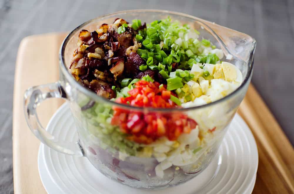 Roasted Garlic & Red Skin Potato Salad is a delicious twist on creamy potato salad with roasted garlic and bacon. This hearty salad is sure to be a hit at your next picnic or potluck!