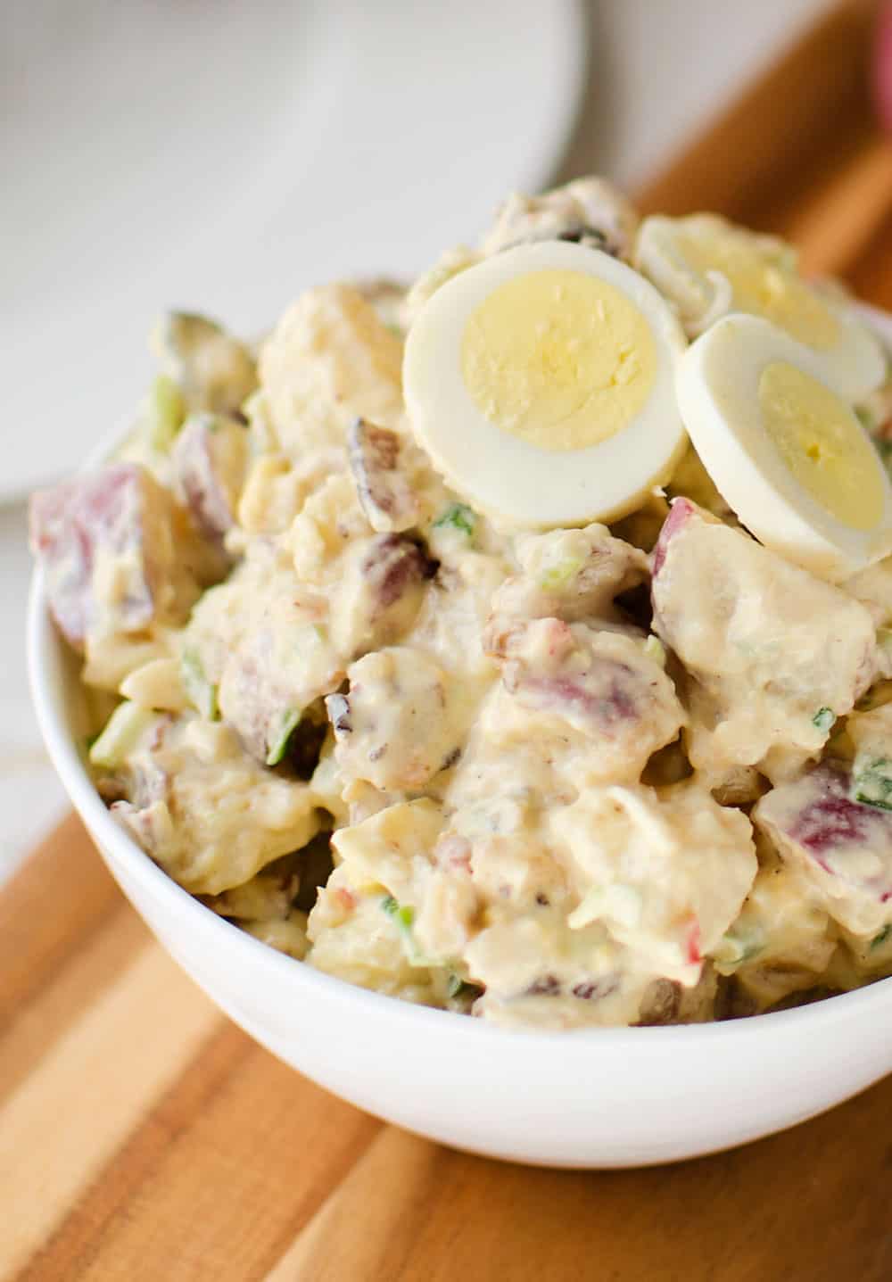Roasted Garlic & Red Skin Potato Salad is a delicious twist on creamy potato salad with roasted garlic and bacon. This hearty salad is sure to be a hit at your next picnic or potluck!