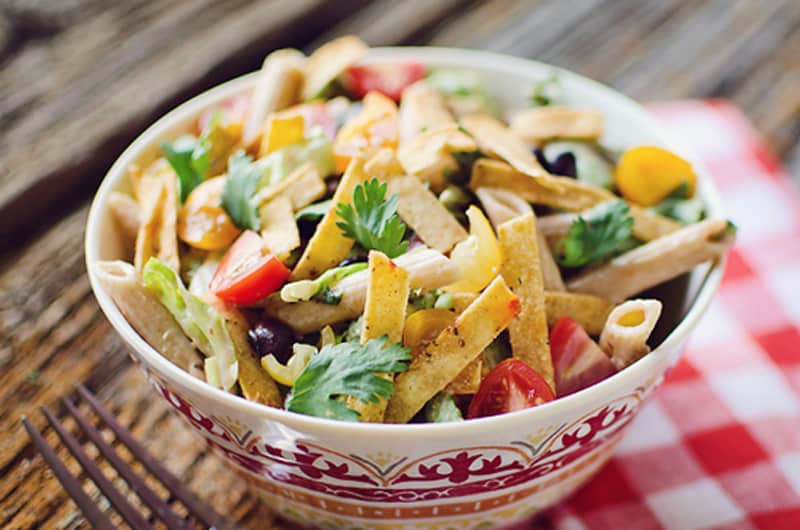 Southwest Penne & Romaine Salad in fiesta bowl on table