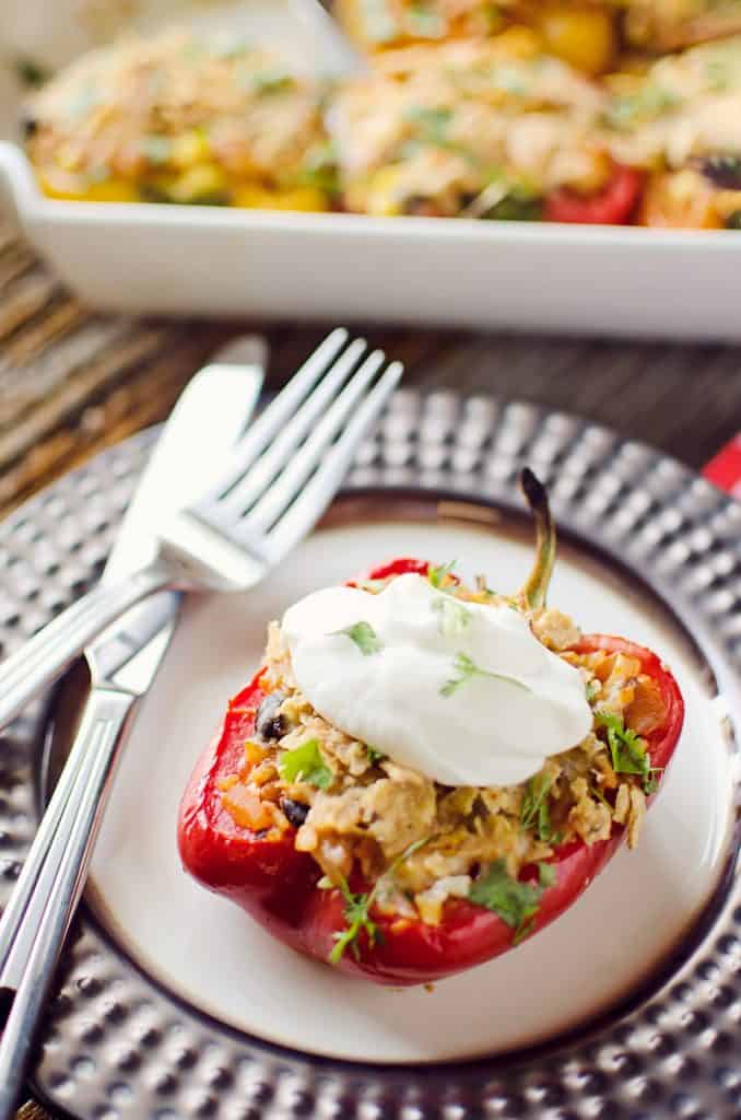Light Chipotle Chicken & Rice Stuffed Peppers on plate with fork and knife