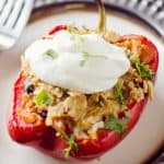 Light Chipotle Chicken & Rice Stuffed Peppers on plate topped with greek yogurt