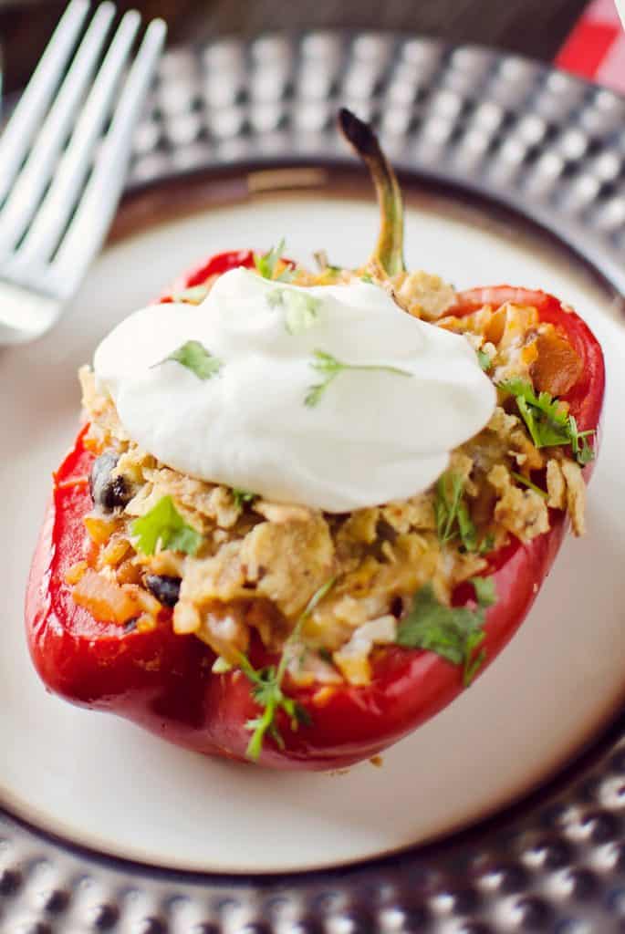 Light Chipotle Chicken & Rice Stuffed Peppers on plate topped with greek yogurt