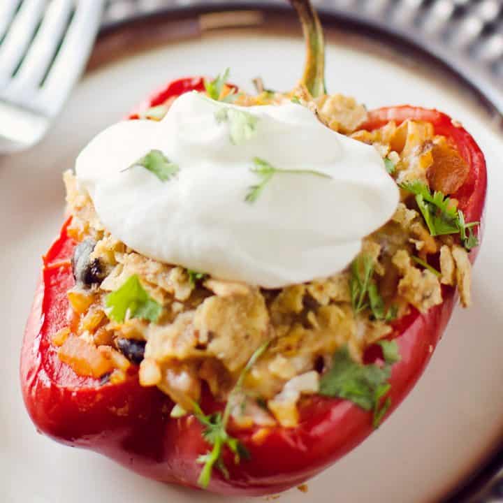 Light Chipotle Chicken & Rice Stuffed Peppers on plate topped with greek yogurt