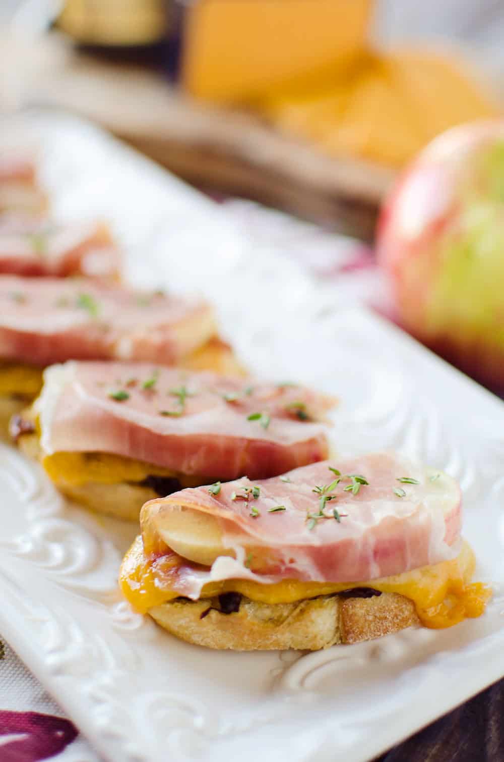 caramelized-onion-and-cheddar-crostinis-with-prociutto-wrapped-apples-appetizer