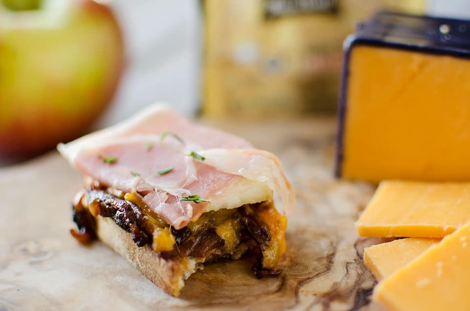 Caramelized Onion & Cheddar Crostinis with Prosciutto Wrapped Apples - Krafted Koch - A sophisticated appetizer made with smooth Boar's Head Sharp Cheddar Cheese, a recipe perfect for the holidays!