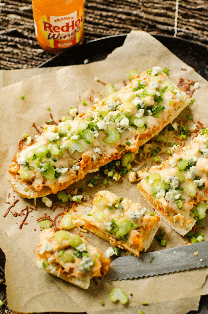 buffalo chicken french bread sliced on pan with knife