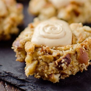 Salted Caramel Pretzel Thumbprint Cookies - Krafted Koch - A fantastic cookie recipe that will impress your guests with a dense, but moist cookie rolled in crunchy pretzels and topped with rich salted caramel frosting!