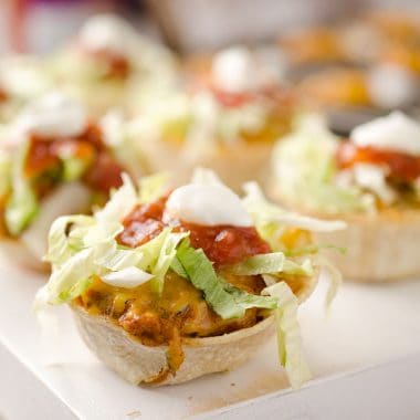 Light Mini Turkey Taco Cups - Krafted Koch - Tortilla cups filled with taco seasoned turkey and topped with lettuce, salsa and sour cream for the perfect healthy appetizer recipe! #Healthy #Appetizer #Light #Lunch