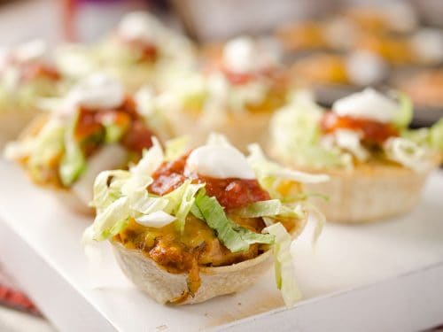 Light Mini Turkey Taco Cups - Krafted Koch - Tortilla cups filled with taco seasoned turkey and topped with lettuce, salsa and sour cream for the perfect healthy appetizer recipe! #Healthy #Appetizer #Light #Lunch