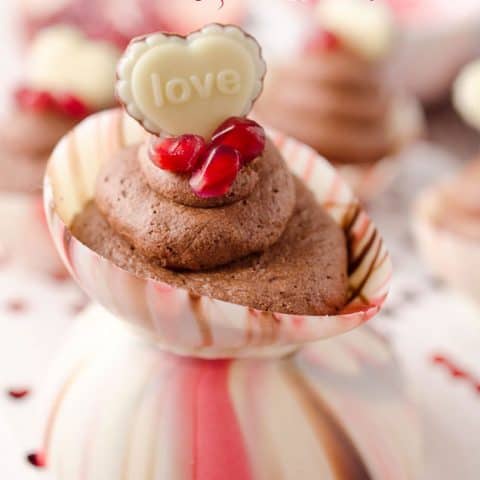 Pomegranate Chocolate Mousse Bowls are the perfect little cups of dessert with pomegranate chocolate mousse filling up these adorable bowls made from swirled Ghirardelli wafers and topped with pearls of pomegranate and chocolate hearts for a festive and colorful Valentine's recipe that will impress your loved one! #Valentines #Ghirardelli #Chocolate #Dessert