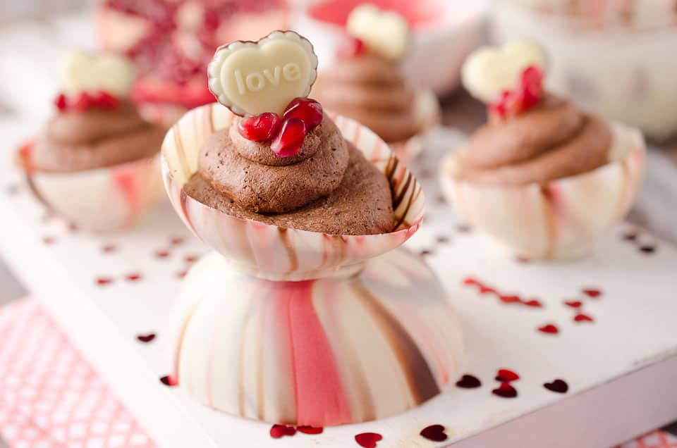 Pomegranate Chocolate Mousse Bowls are the perfect little cups of dessert with pomegranate and dark chocolate mousse filling up these adorable bowls made from swirled Ghirardelli melting wafers and topped with pomegranate seeds and chocolate hearts for a festive and colorful Valentine's recipe that will impress your loved one this Valentine's Day! #Valentines #Ghirardelli #Chocolate #Dessert