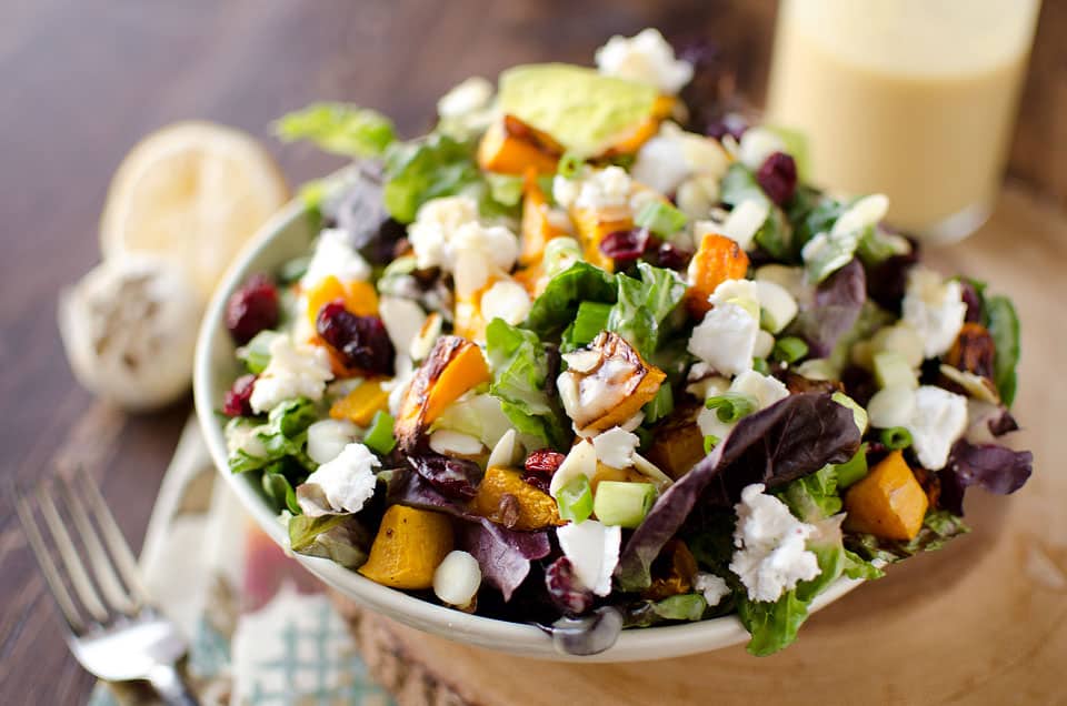 Roasted Squash & Cranberry Salad - Krafted Koch - A flavorful harvest salad loaded with roasted butternut squash, creamy goat cheese and dried cranberries for a meatless meal that will satisfy all your senses!