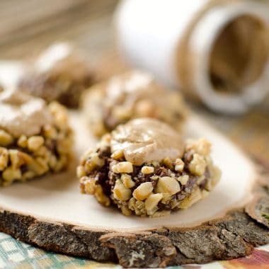 Peanut Butter & Chocolate Thumbprint Cookies - Krafted Koch - A rich chocolate cookie recipe rolled in walnuts and filled with sweet peanut butter frosting for the perfect cookie! #Cookie #Recipe #PeanutButter #Chocolate