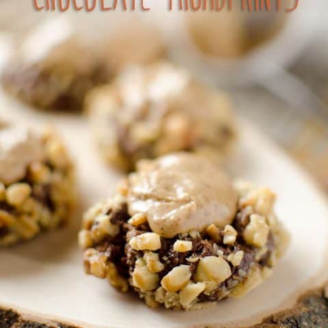 Peanut Butter & Chocolate Thumbprint Cookies - Krafted Koch - A rich chocolate cookie recipe rolled in walnuts and filled with sweet peanut butter frosting for the perfect cookie! #Cookie #Recipe #PeanutButter #Chocolate