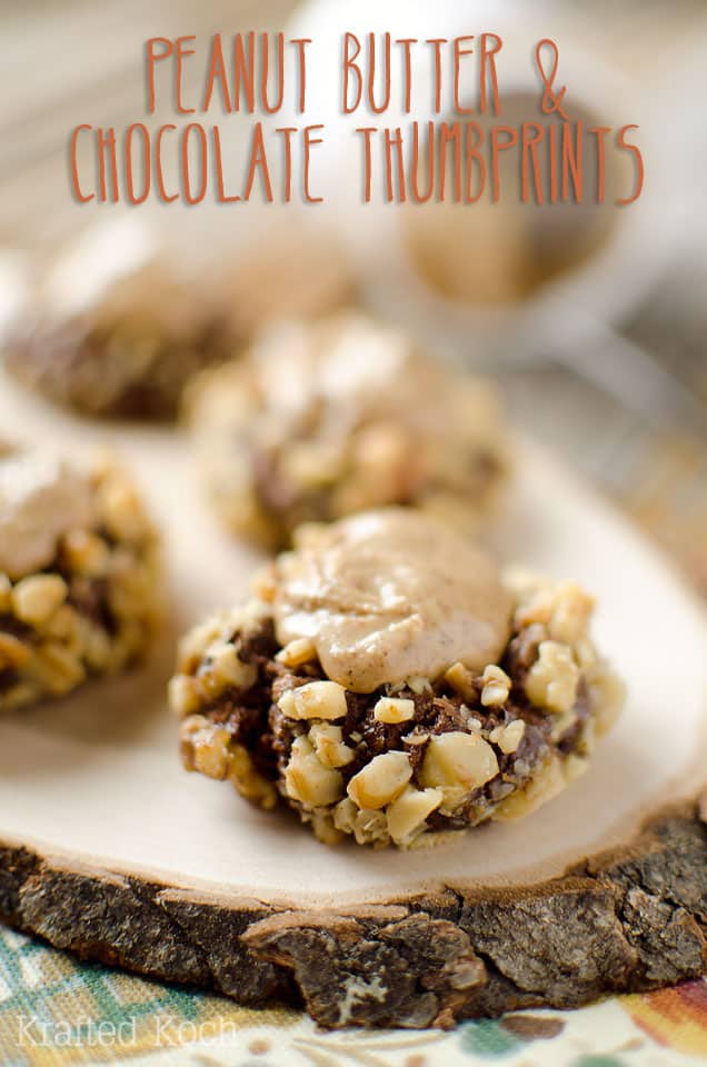 Peanut Butter & Chocolate Thumbprint Cookies - Krafted Koch - A rich chocolate cookie recipe rolled in walnuts and filled with sweet peanut butter frosting for the perfect cookie! #Cookie #Recipe #PeanutButter #Chocolate