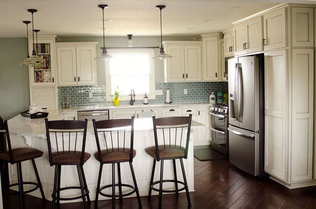 Bold, Small Kitchen with Green Cabinets and Slate Appliances