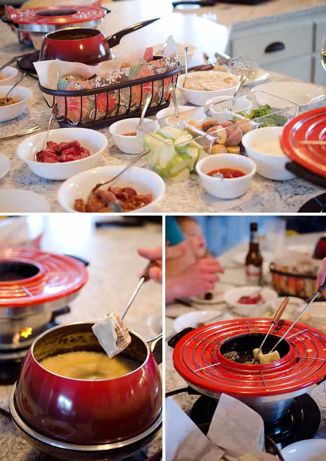 fondue spread on kitchen table with meats, cheese, bread and more