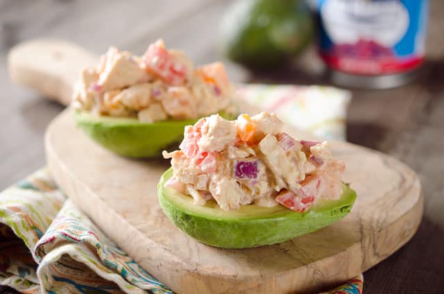 Chipotle Chicken Salad Stuffed Avocados - A low-carb recipe full of fresh vegetables and flavor from a spicy chipotle sauce for a light and healthy packed lunch or dinner idea!