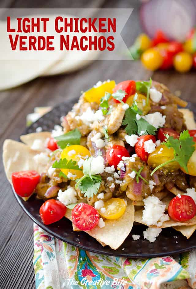 Light Chicken Verde Nachos are a healthy appetizer or fun dinner idea with a pile of baked corn tortillas topped with chicken breasts in a salsa verde and fresh tomatoes and queso fresco. #Light #Chicken #Healthy #Nachos