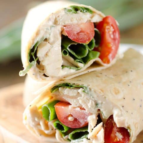 Light Chipotle Ranch Chicken Wrap is an easy wrap with rotisserie chicken, tomatoes, spinach, green onions and a spicy Chipotle Greek yogurt sauce for a healthy lunch! #Chicken #Wrap #Lunch