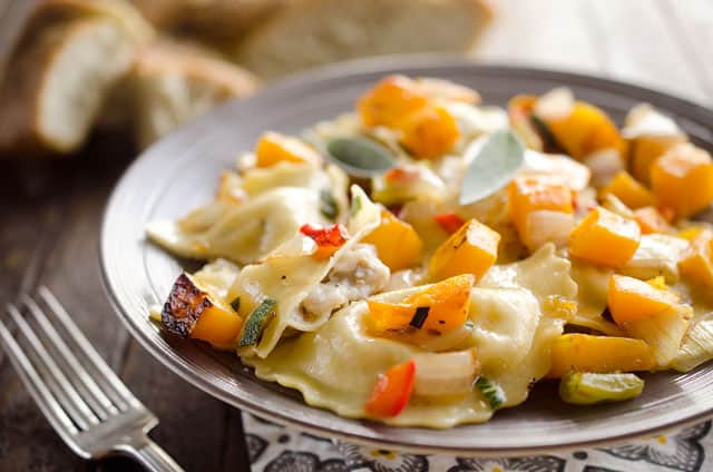 Roasted Squash & Sausage Ravioli is easy weeknight comfort food with roasted butternut squash, onions and bell peppers tossed with sausage ravioli and a butter sage sauce. #Squash #Sausage #Pasta #ComfortFood #Ravioli