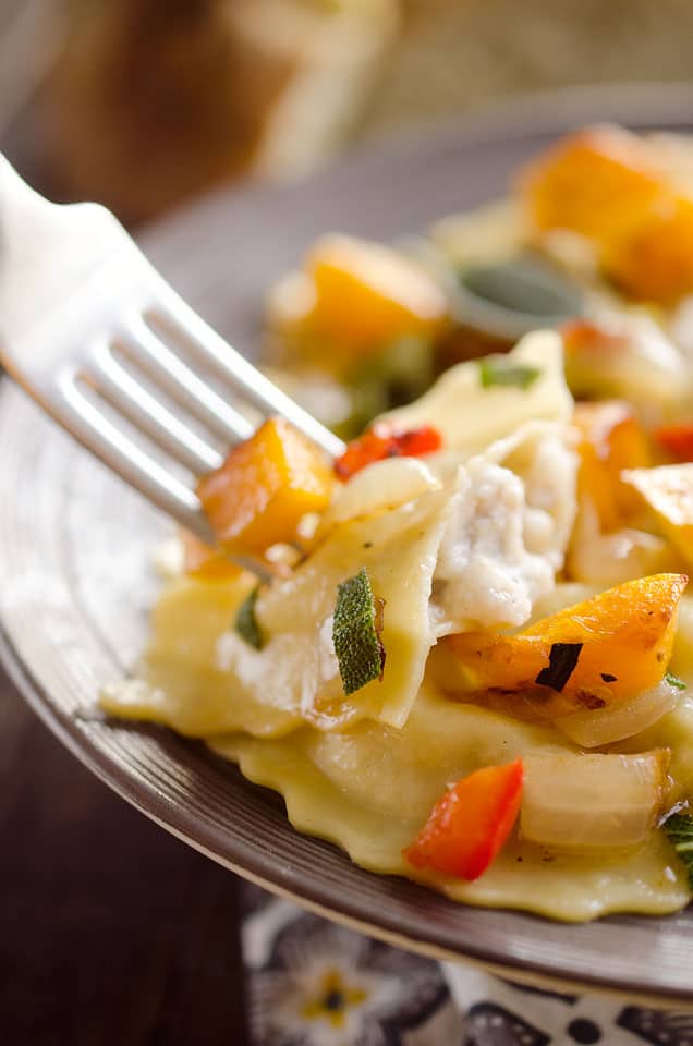 Roasted Squash & Sausage Ravioli is easy weeknight comfort food with roasted butternut squash, onions and bell peppers tossed with sausage ravioli and a butter sage sauce. #Squash #Sausage #Pasta #ComfortFood #Ravioli
