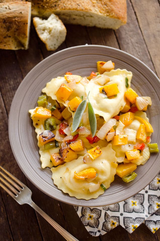 Roasted Squash & Sausage Ravioli is easy weeknight comfort food with roasted butternut squash, onions and bell peppers tossed with sausage ravioli and a butter sage sauce. #Squash #Sausage #Pasta #ComfortFood #Ravioli