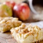 Apple Cheesecake Crumble Bars - This creamy fall treat is full of tart apples and decadent cheesecake with a nutty granola crust for a delicious dessert! #Apple #Bars #Dessert #Cheesecake
