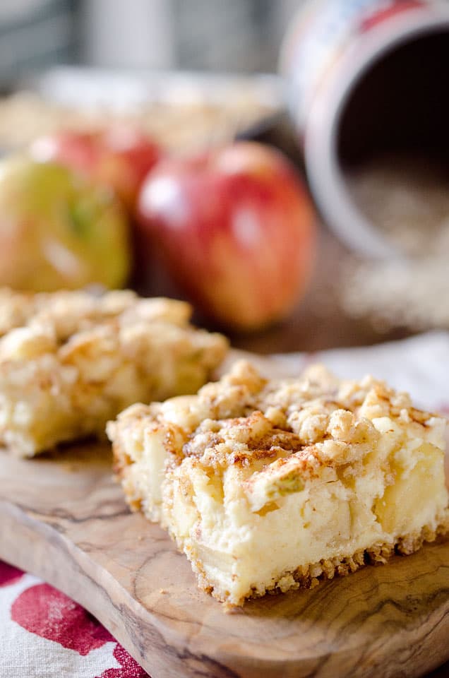 Apple Cheesecake Crumble Bars - This creamy fall treat is full of tart apples and decadent cheesecake with a nutty granola crust for a delicious dessert! #Apple #Bars #Dessert #Cheesecake