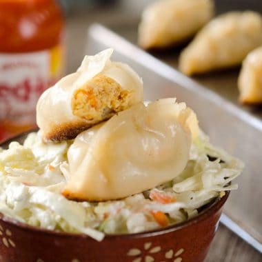 Buffalo Chicken Potstickers are a surprisingly easy and healthy dinner with chewy wrappers filled with lean ground chicken, vegetables and buffalo sauce.