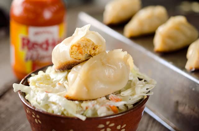 Buffalo Chicken Potstickers are a surprisingly easy and healthy dinner with chewy wrappers filled with lean ground chicken, vegetables and buffalo sauce.