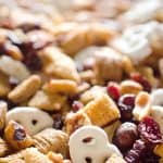 Sweet & Salty Cranberry Snack Mix is a party favorite filled with buttery cinnamon Chex Mix, yogurt covered pretzels, dried cranberries and mixed nuts.