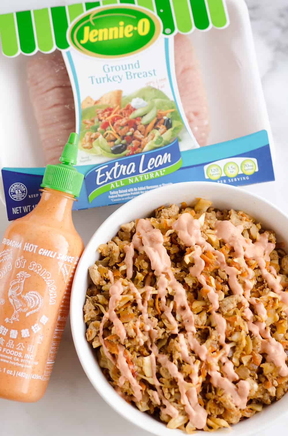 Turkey Egg Roll Bowl with Creamy Sriracha is an amazingly healthy and delicious bowl of goodness perfect for lunch or dinner! Sauteed cabbage, carrots, onion and ground turkey are tossed with an Asian inspired sauce and topped with a creamy Greek yogurt sriracha mayo sauce.