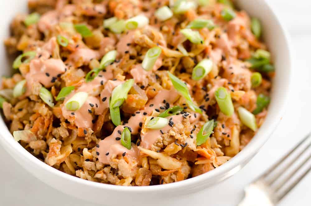 Turkey Egg Roll Bowl with Creamy Sriracha is an amazingly healthy and delicious bowl of goodness perfect for lunch or dinner! Sauteed cabbage, carrots, onion and ground turkey are tossed with an Asian inspired sauce and topped with a creamy Greek yogurt sriracha mayo sauce.