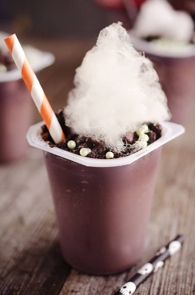 Witch's Brew Pudding Cups - These witch's cauldrons are made with delicious chocolate Snack Packs topped with crushed oreos, bubble sprinkles and cotton candy for a spooky Halloween treats that kids and adults will all love! #Halloween #Pudding #Chocolate