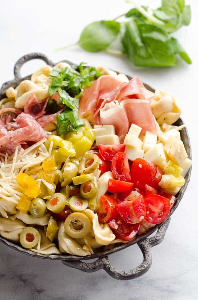 Antipasto Tortellini Pasta Salad is hearty side dish that is a perfect addition to any holiday meal, loaded with prosciutto, salami, Crystal Farms cheese, tomatoes, olives and more!