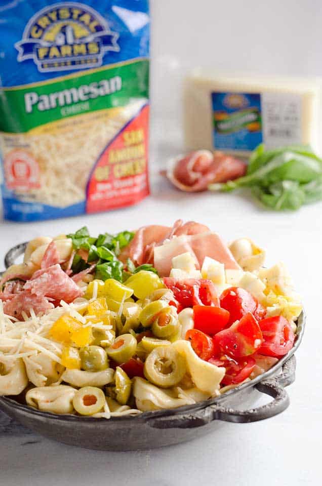 Antipasto Tortellini Pasta Salad is hearty side dish that is a perfect addition to any holiday meal, loaded with prosciutto, salami, Crystal Farms cheese, tomatoes, olives and more!