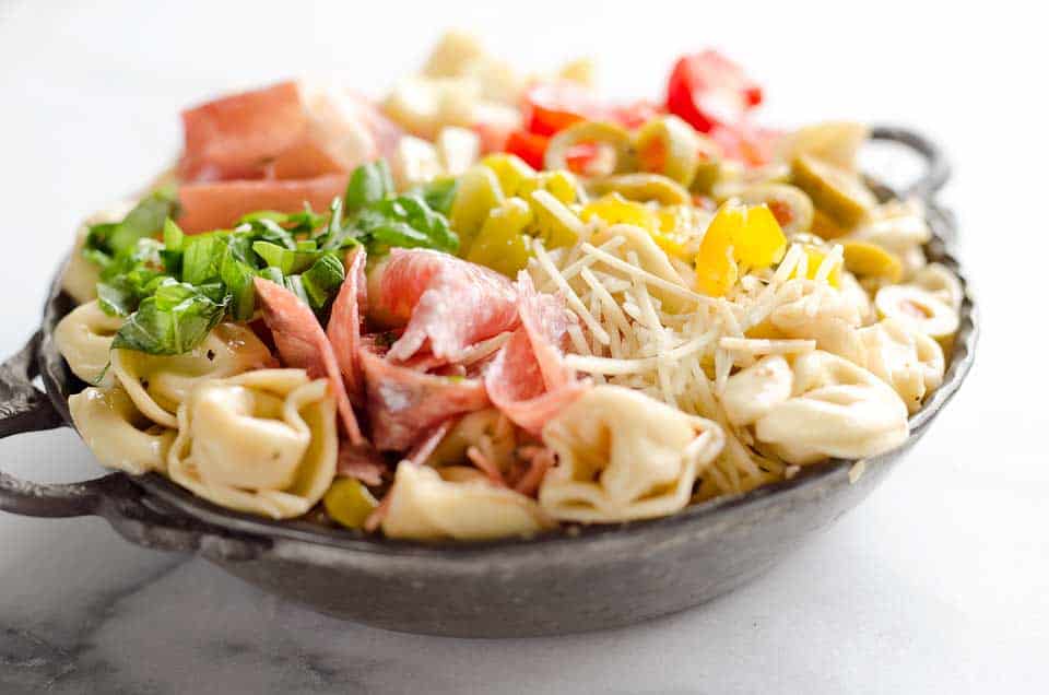 Antipasto Tortellini Pasta Salad is hearty side dish that is a perfect addition to any holiday meal, loaded with prosciutto, salami, Crystal Farms cheese, tomatoes, olives and more!