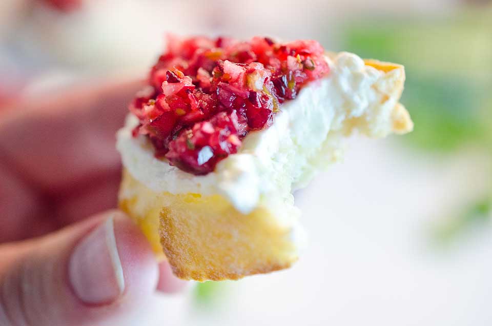 Cranberry Cream Cheese Bruschetta are a fresh twist on a classic appetizer. Toasted french bread is topped with cream cheese and a spicy cranberry salsa for an hors d'oeuvre perfect for any holiday party!
