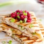 Light Cranberry Turkey Quesadilla are a healthy and easy meal perfect for using up all of that leftover turkey from Thanksgiving! Fill a light tortilla with turkey, havarti cheese and green onions and top it with cranberry salsa for a delicious and unique dinner after the holidays!