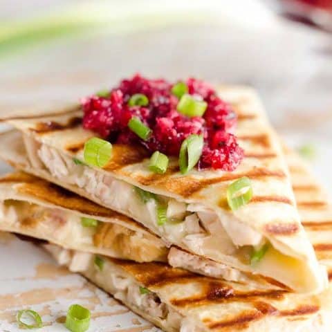 Light Cranberry Turkey Quesadilla are a healthy and easy meal perfect for using up all of that leftover turkey from Thanksgiving! Fill a light tortilla with turkey, havarti cheese and green onions and top it with cranberry salsa for a delicious and unique dinner after the holidays!